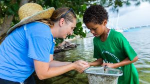 Treyvon Stanford looks at shrimp with Mote Community Engagement Coordinator Elaina Todd.